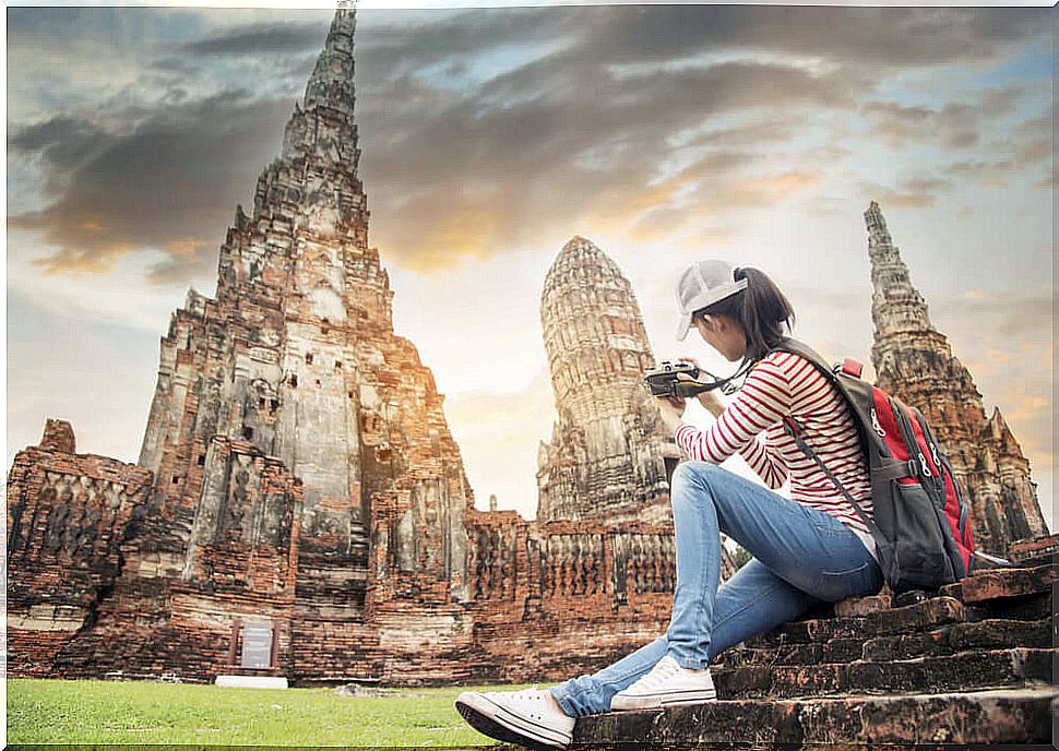 Woman in a temple in Bali, enjoying how a trip changes you