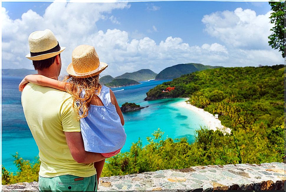 Traveling with children, father and daughter on the beach