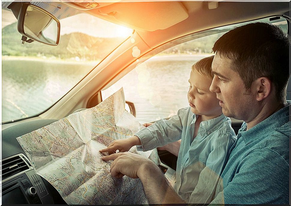 Father in the car going on a trip with children