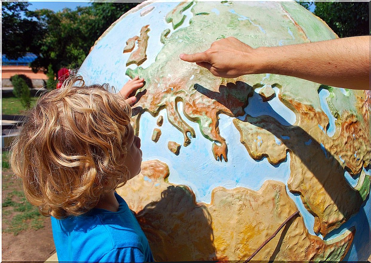 Boy looking at world globe