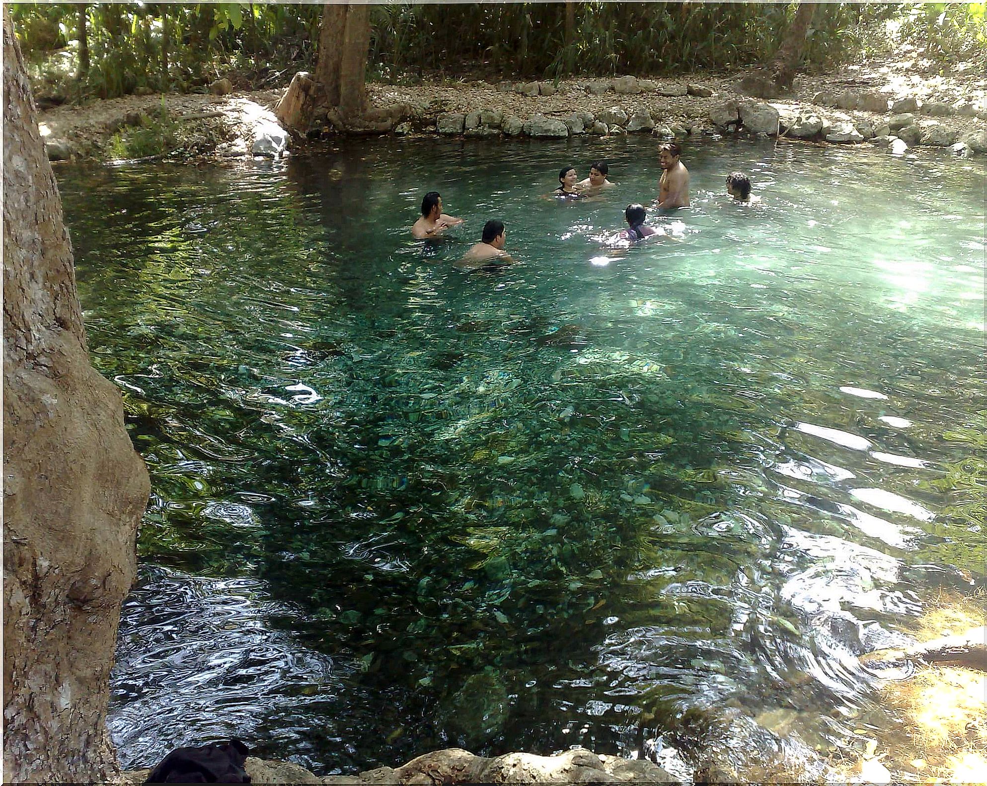 Tourists bathe in a waterhole in Hampolol, Campeche.