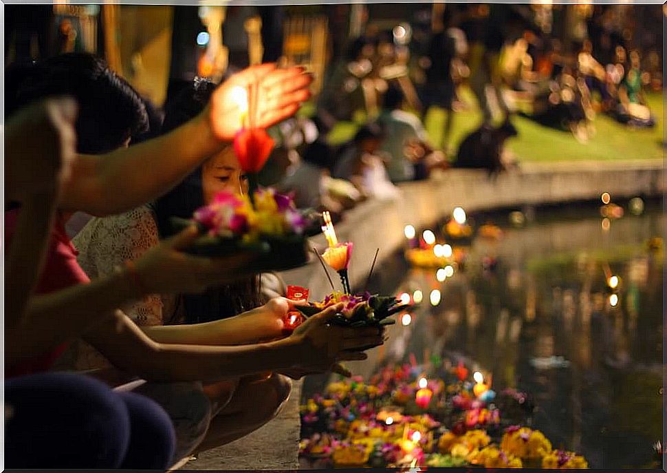 Genta throwing lights into the water at the Loi Kratong Festival 