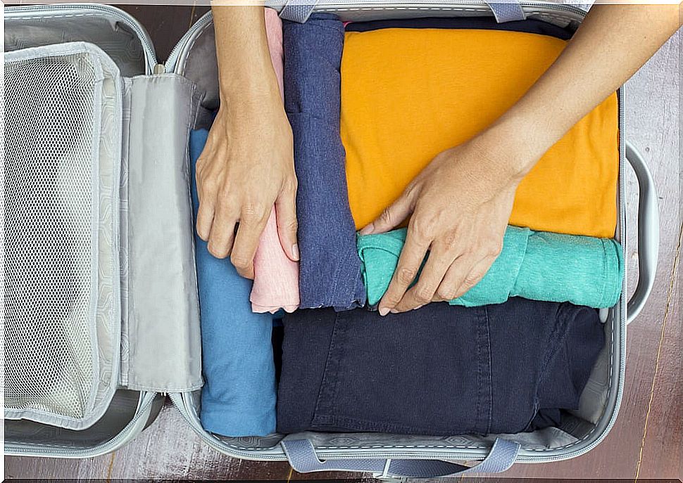 Woman packing suitcase